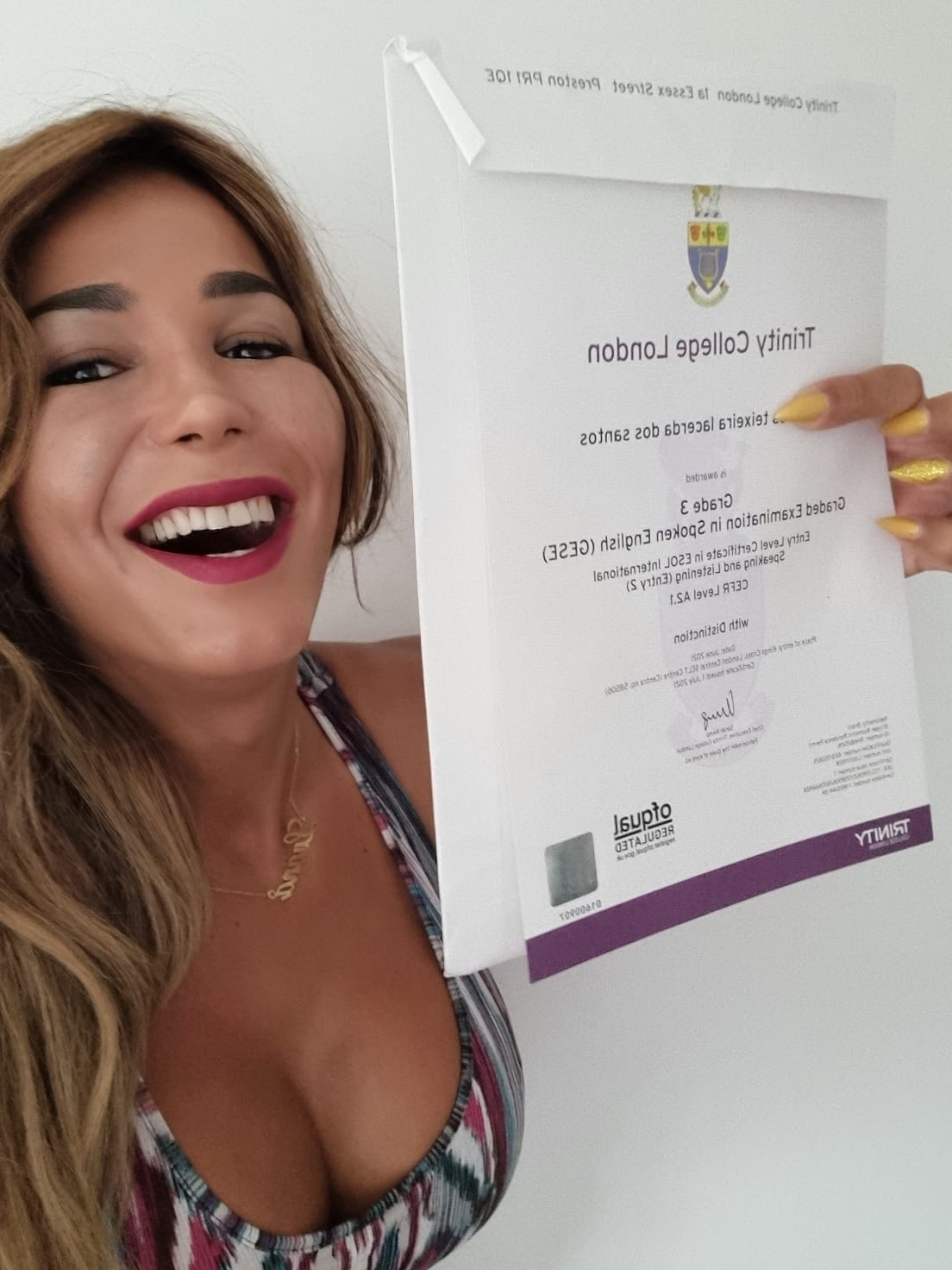 Excited student showing off her Trinity College London exam certificate.